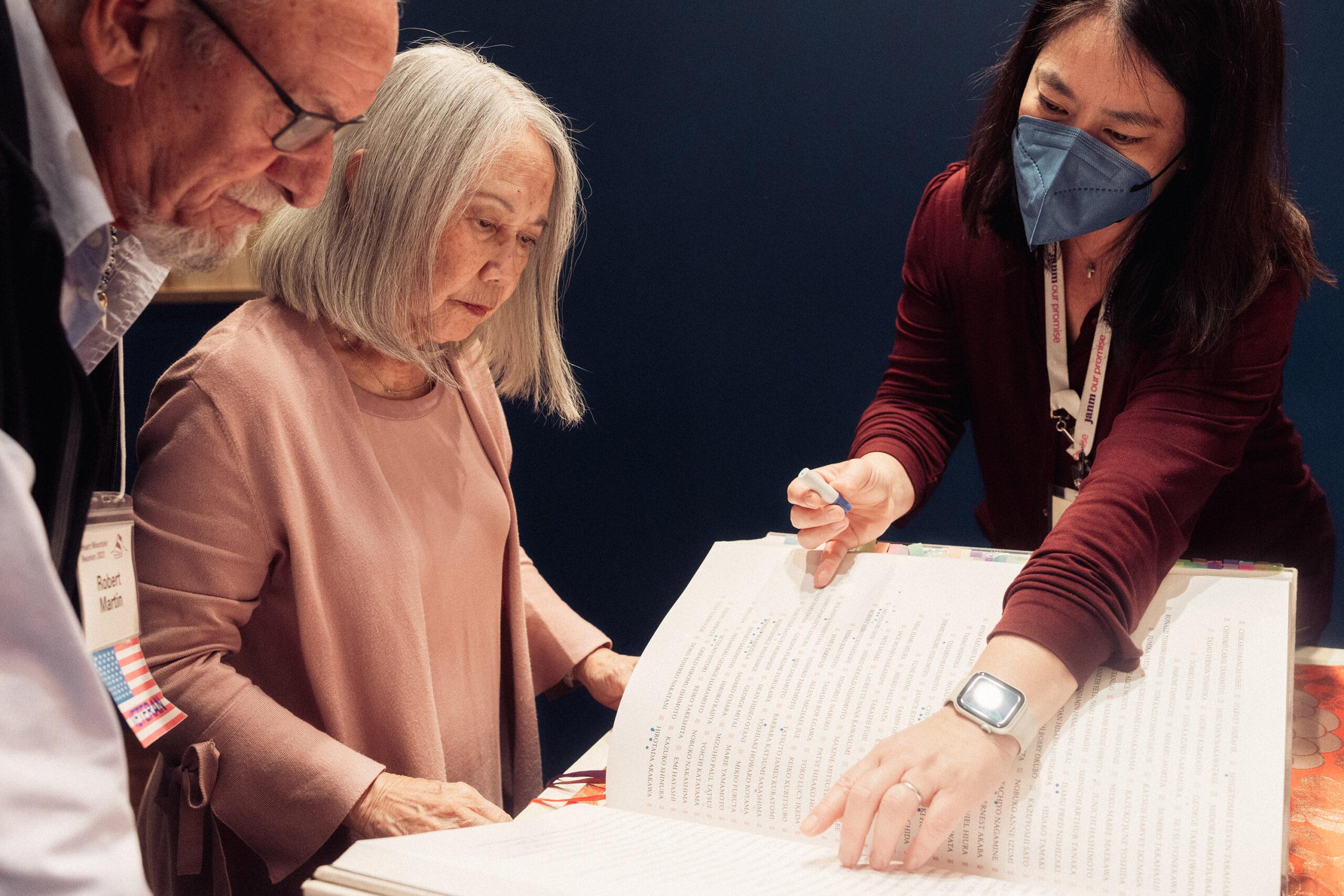 Jo Anne Naka stamps the Ireichō with her husband Robert at the Japanese American National Museum, in Los Angeles.